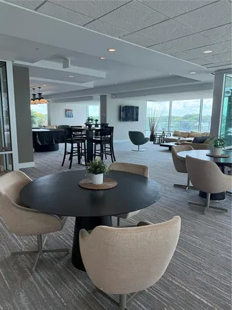 a living room with dining room and kitchen view