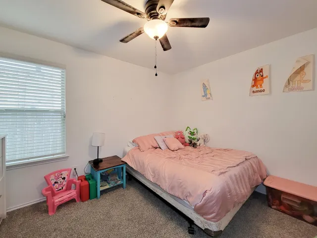 a bedroom with a bed and chandelier