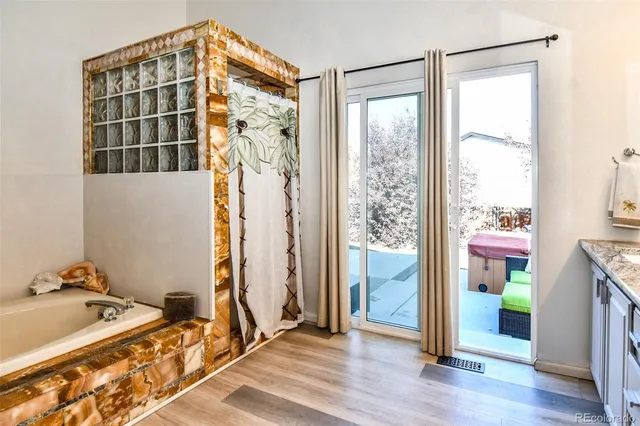 a spacious bedroom with a bed and a window