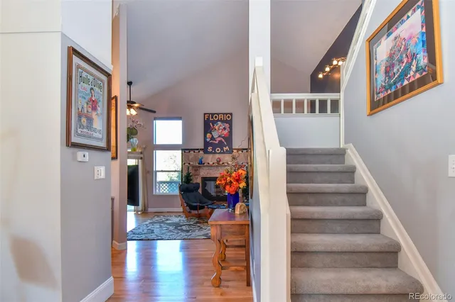 a view of a hallway with wooden floor and furniture