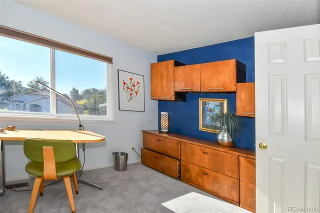 a room with furniture a flat screen tv and a window