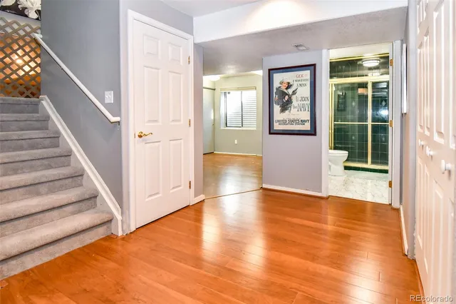 a view of an entryway with wooden floor and door