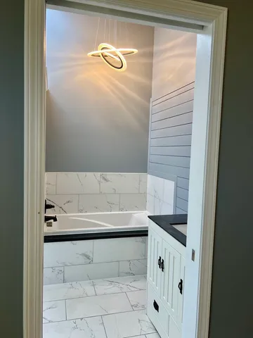 a living room with hard wood floors and a fireplace
