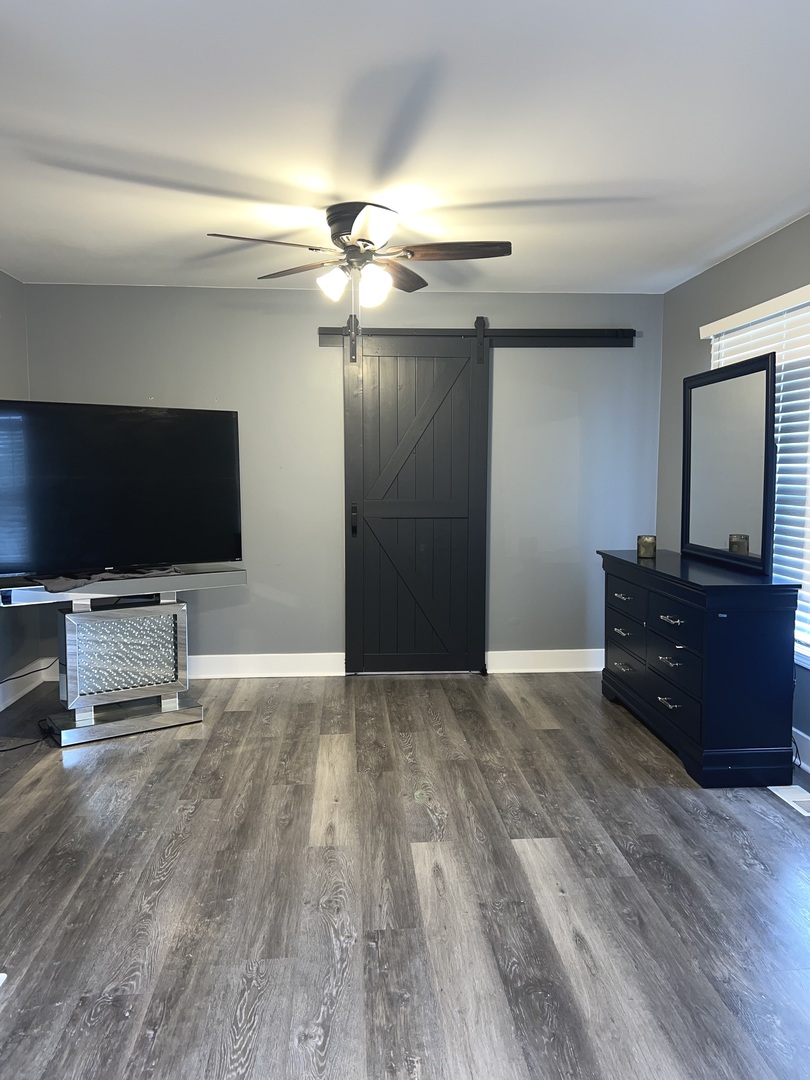 2472 Worthington Drive Aurora, IL 60506 - Photo 19 of 26 an empty room with wooden floor cabinet and flat screen tv
