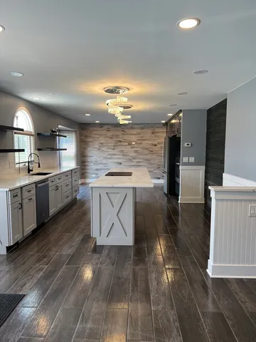 a kitchen with stainless steel appliances a stove a sink and a refrigerator