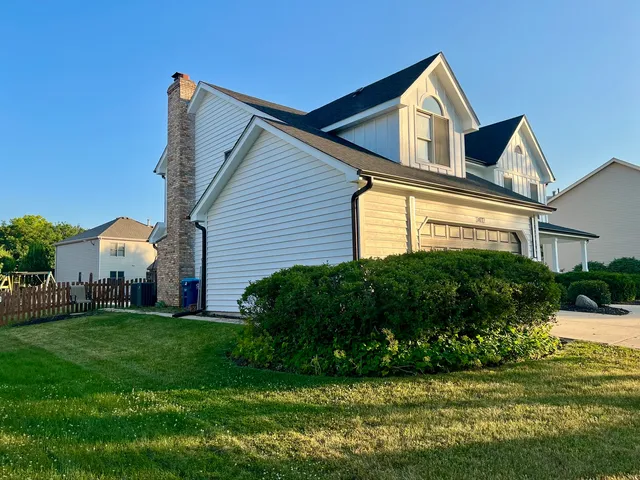 a front view of a house with a yard and outdoor seating