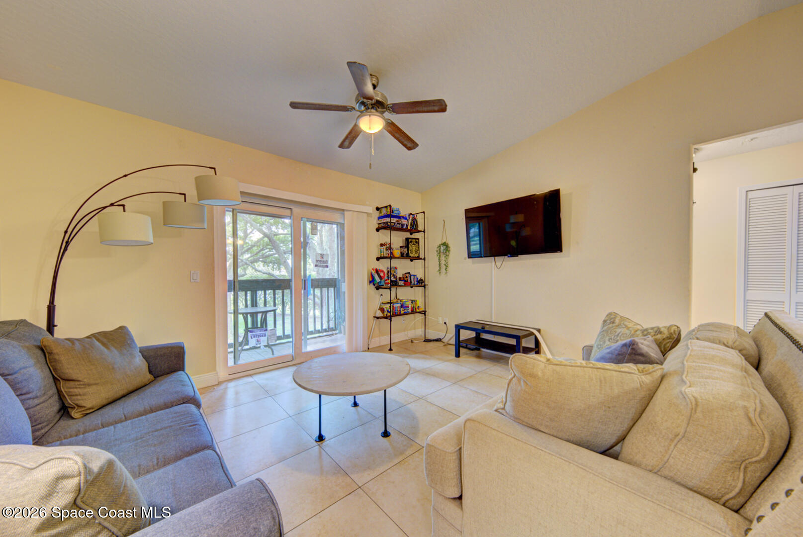 7667 North Wickham Road, Unit 1416 Melbourne, FL 32940 - Photo 13 of 41 a living room with furniture and a flat screen tv