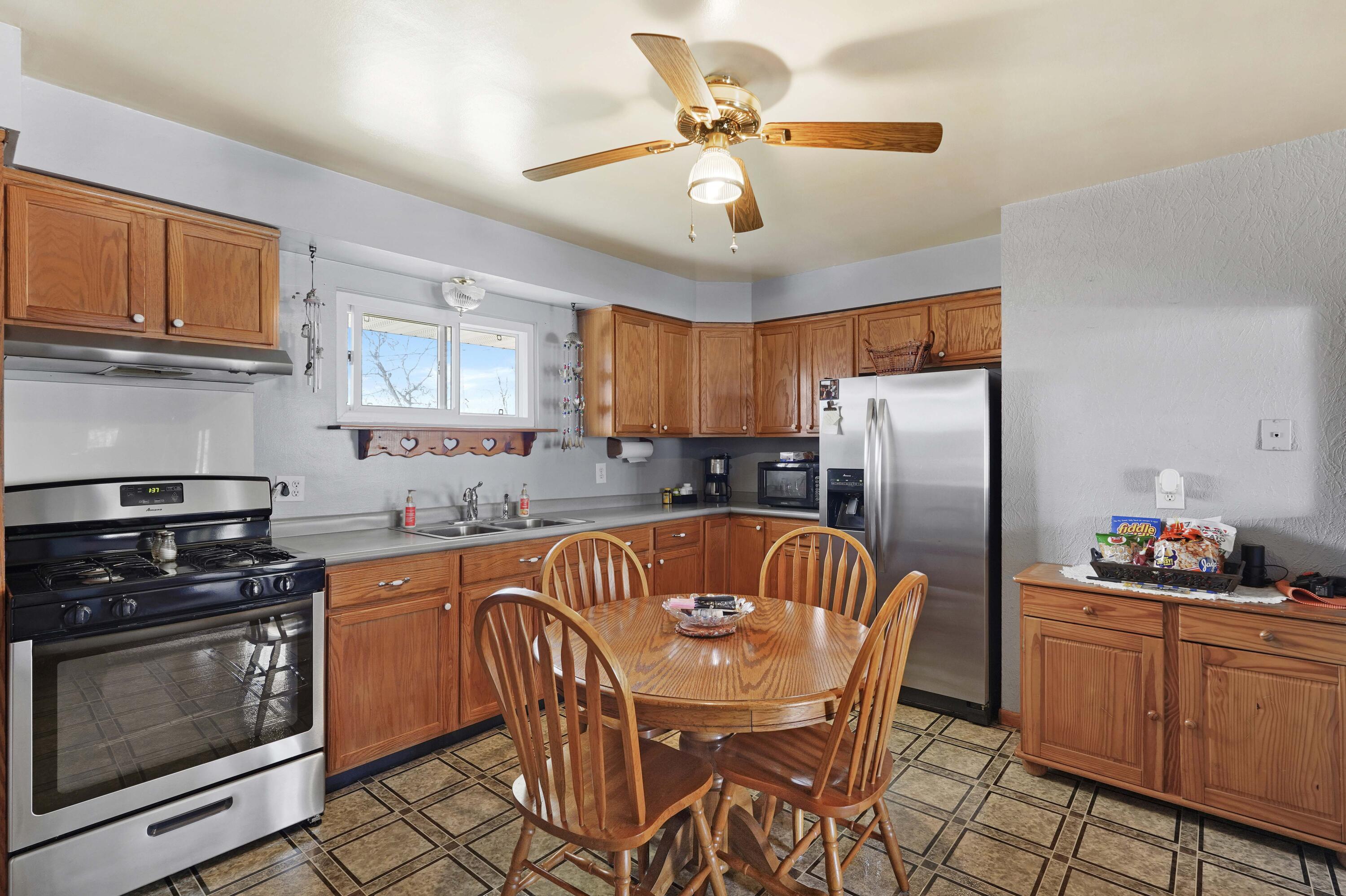 4900 Arthur Street Gary, IN 46408 - Photo 2 of 21 a kitchen with stainless steel appliances granite countertop a stove a sink dishwasher a refrigerator with a dining table and chairs