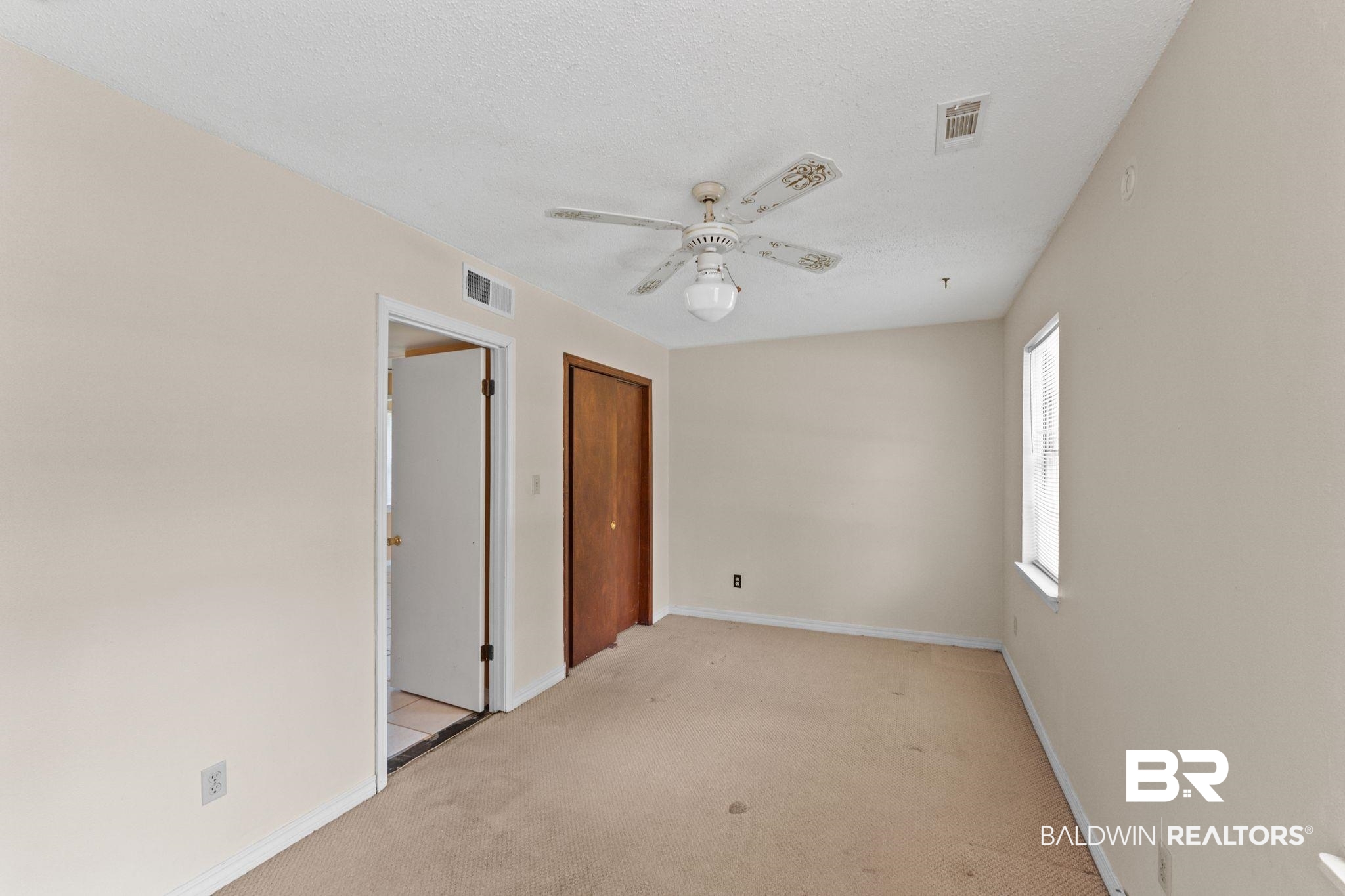 14095 Riverside Drive Foley, AL 36535 - Photo 19 of 30 Unfurnished room featuring light carpet, a ceiling fan, and a textured ceiling