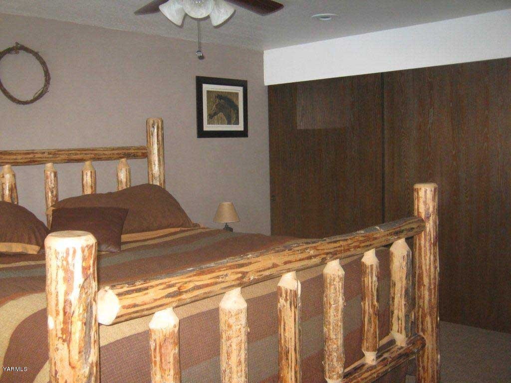 8500 Campbell Road Toppenish, WA 98948 - Photo 14 of 45 a bedroom with a bed and a chandelier