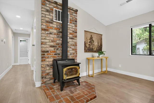 a kitchen with a stove a microwave and dining table