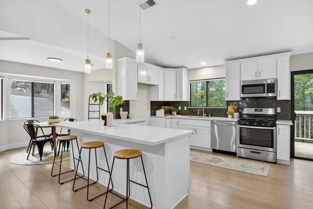 a view of a dining room with a table and chairs