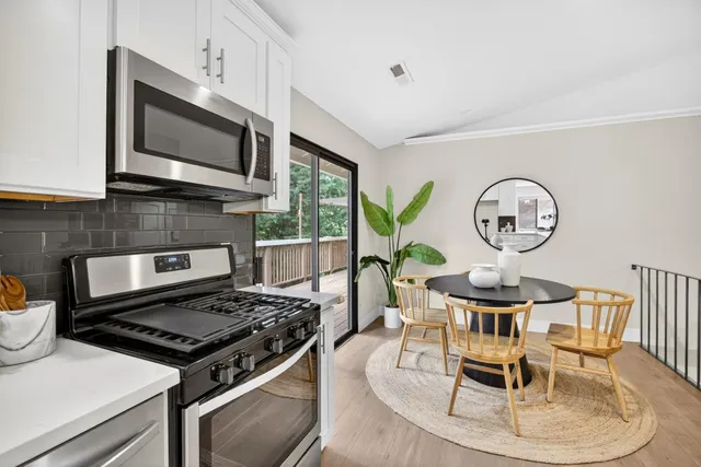 a view of a bedroom with wooden floor and balcony