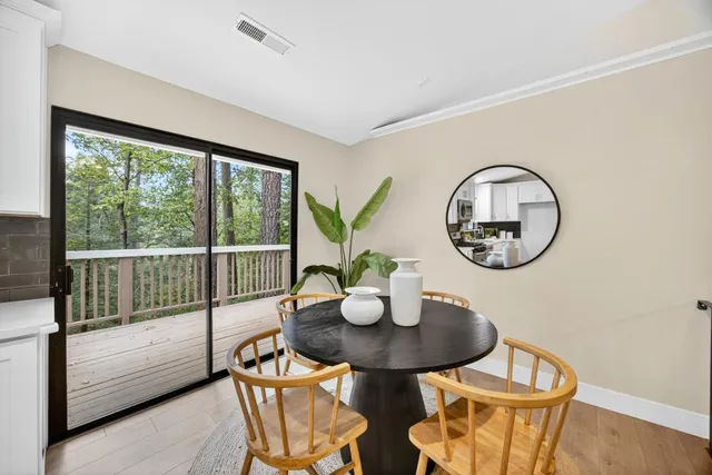 a bedroom with a large bed and a potted plant