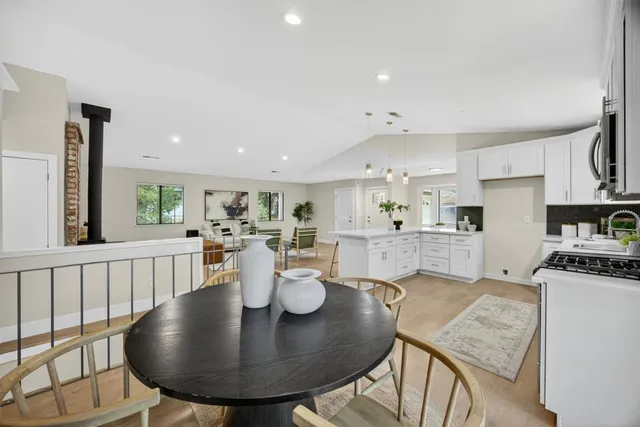 a bedroom with a bed and a dresser next to a window