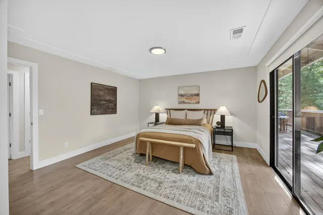 a living room with a window and a wooden floor