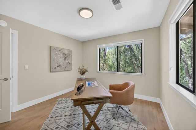a view of a hallway with wooden floor and entryway