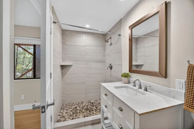 a view of a patio with table and chairs with wooden floor and fence