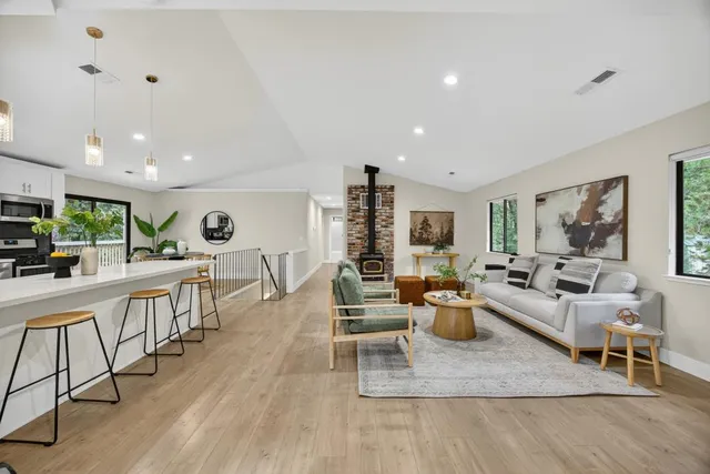 a living room with furniture and kitchen view