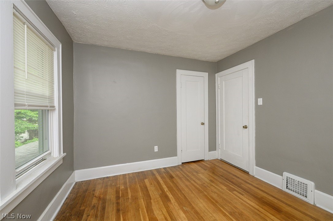 1222 Ridge Road Northwest Canton, OH 44703 - Photo 23 of 32 Upstairs bedroom with multiple windows and wood flooring