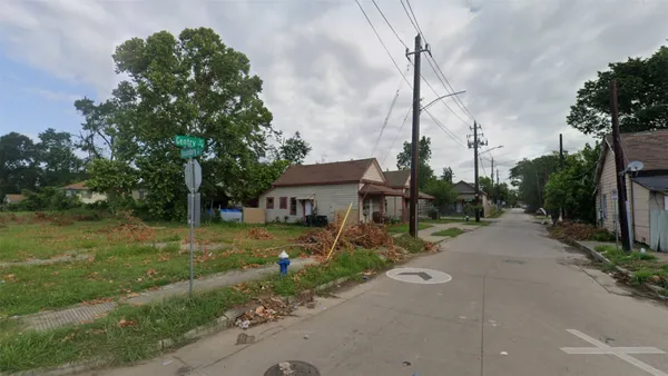 a view of a house next to a yard