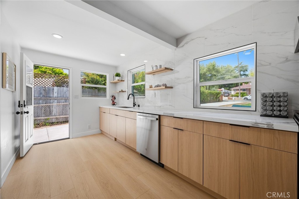 1280 East Woodbury Road Pasadena, CA 91104 - Photo 23 of 40 a large white kitchen with a large window