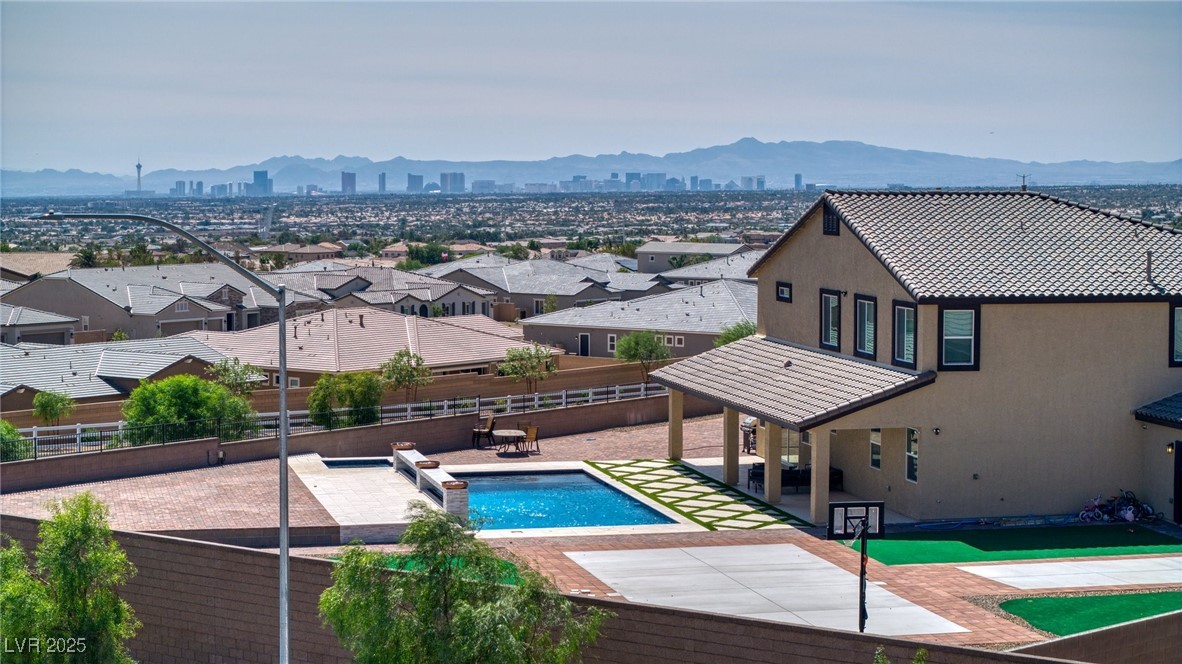 5592 Hickory Tree Street Las Vegas, NV 89149 - Photo 12 of 87 View of swimming pool with a patio, a fenced backyard, a mountain view, and a view of city
