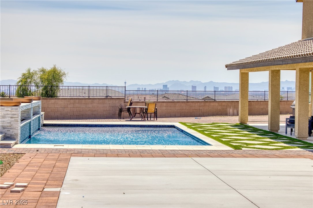 5592 Hickory Tree Street Las Vegas, NV 89149 - Photo 14 of 87 Swimming pool with a patio, a mountain view, and a fenced backyard