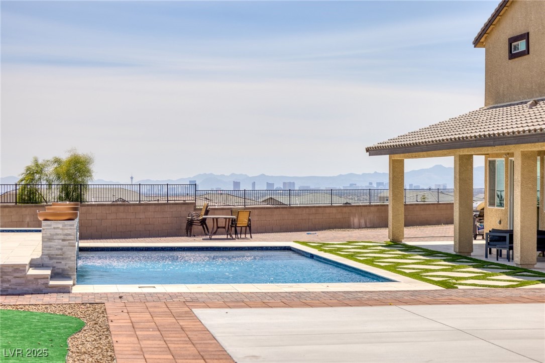 5592 Hickory Tree Street Las Vegas, NV 89149 - Photo 16 of 87 View of swimming pool with a patio area, a fenced backyard, and a mountain view