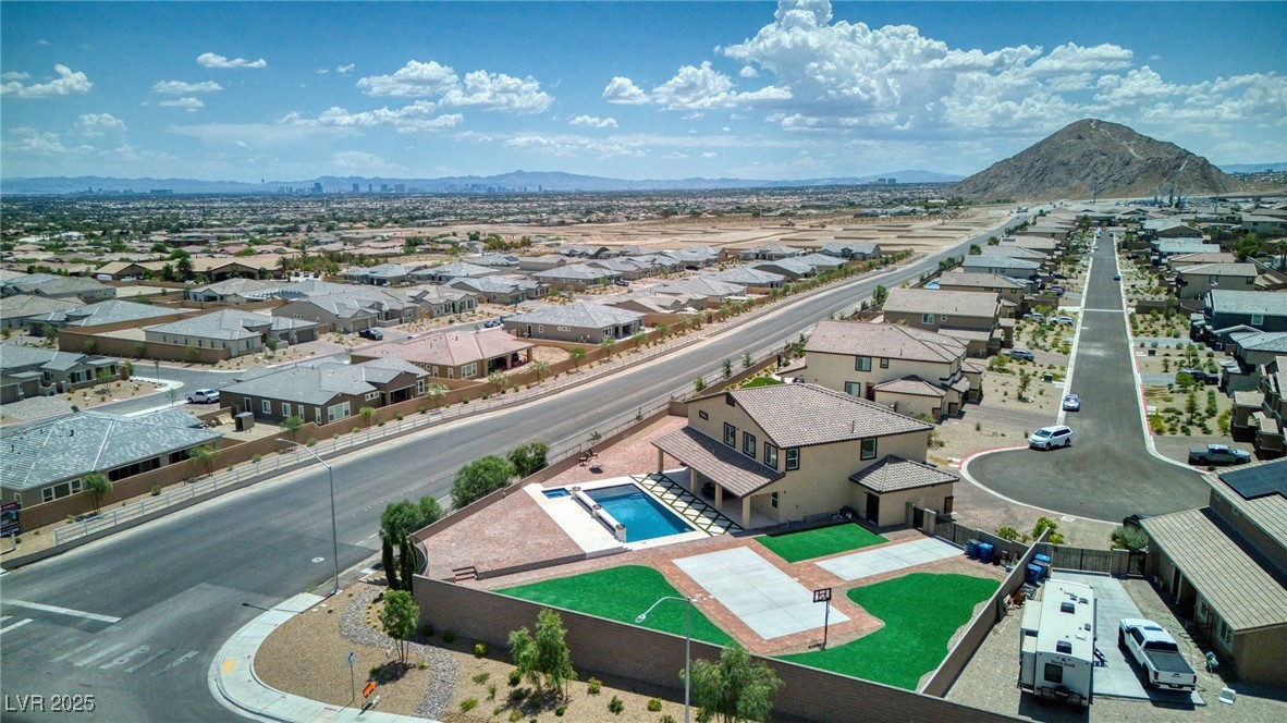 5592 Hickory Tree Street Las Vegas, NV 89149 - Photo 19 of 87 Aerial perspective of suburban area featuring a mountain backdrop and a pool