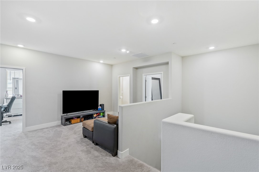 5592 Hickory Tree Street Las Vegas, NV 89149 - Photo 42 of 87 Carpeted living room with an office area and recessed lighting