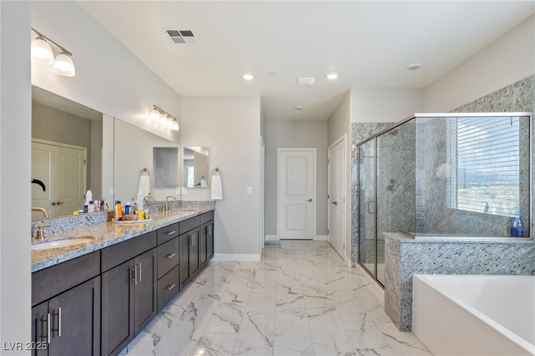 5592 Hickory Tree Street Las Vegas, NV 89149 - Photo 64 of 87 Full bathroom featuring double vanity, a stall shower, recessed lighting, a tub to relax in, and light marble finish floors