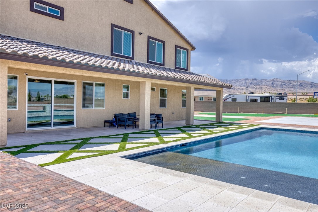 5592 Hickory Tree Street Las Vegas, NV 89149 - Photo 70 of 87 View of pool with a patio area and a mountain view