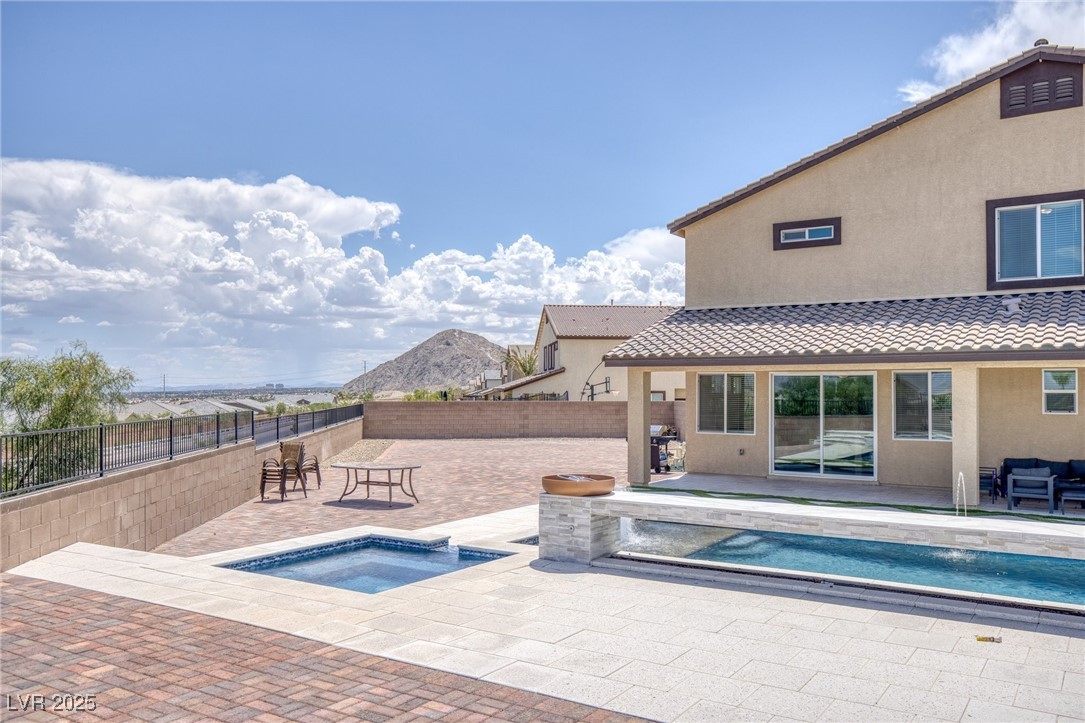5592 Hickory Tree Street Las Vegas, NV 89149 - Photo 78 of 87 View of pool featuring a patio, an in-ground hot tub, a mountain view, and a fenced backyard