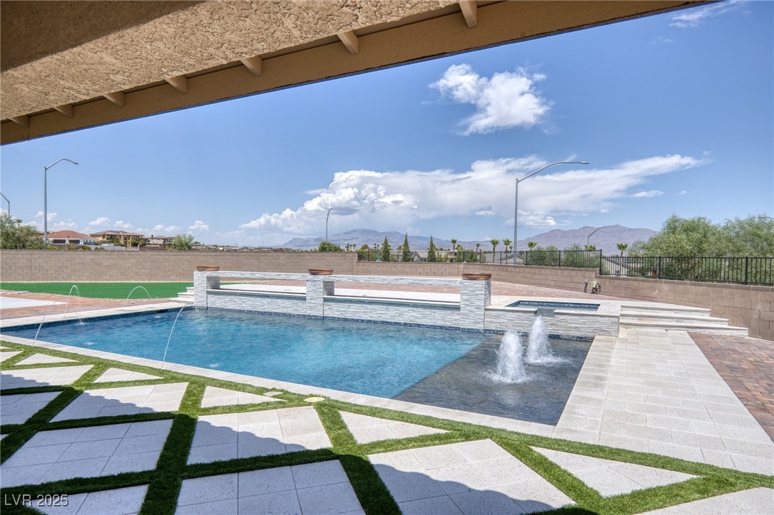 5592 Hickory Tree Street Las Vegas, NV 89149 - Photo 83 of 87 View of pool with a patio, a fenced backyard, a mountain view, and a pool with connected hot tub