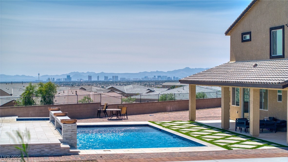 5592 Hickory Tree Street Las Vegas, NV 89149 - Photo 10 of 87 View of swimming pool featuring a patio area, a fenced backyard, and a mountain view