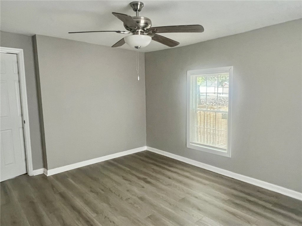 301 Hammett Street Honea Path, SC 29654 - Photo 6 of 14 This airy bedroom features sleek wood flooring and ample natural light.