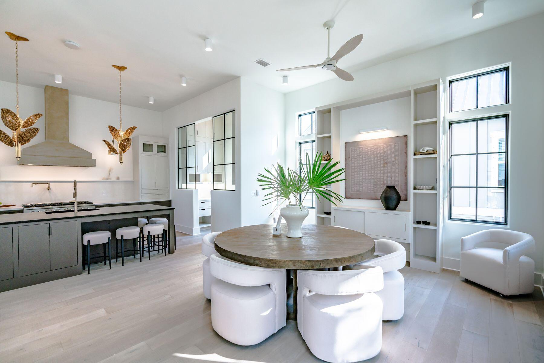 143 Grande Pointe Cir Inlet Beach Inlet Beach, FL 32461 - Photo 22 of 51 a kitchen with stainless steel appliances granite countertop a stove a refrigerator a sink a dining table and chairs with wooden floor