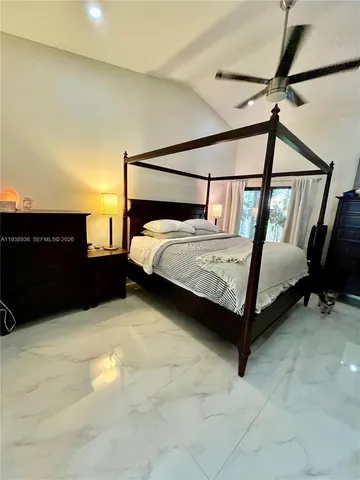 a bed sitting in a bedroom next to a cabinet