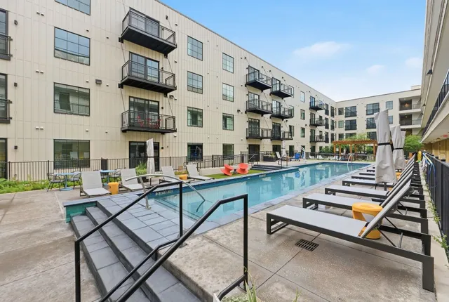 a sitting area with pool table and chairs