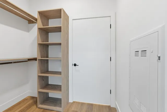 a view of walk in closet with empty racks
