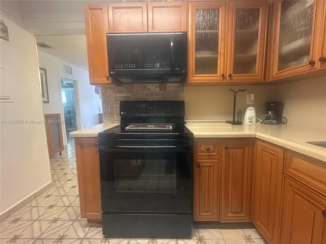 a kitchen with a stove and a microwave