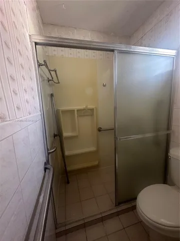 a bathroom with a glass shower door