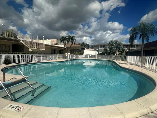 a view of a swimming pool with a garden