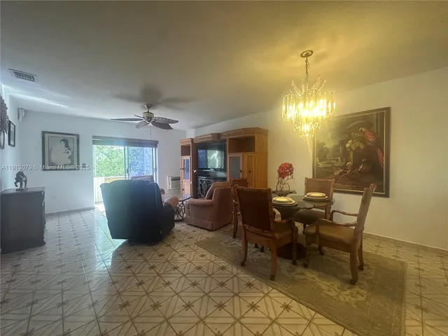 a living room with furniture a lamp and a chandelier