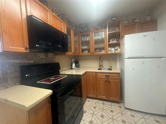 a kitchen with a sink a stove and refrigerator