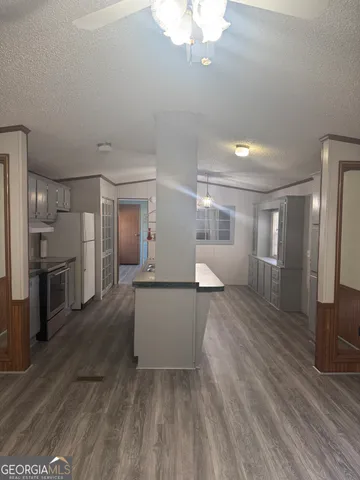 a view of a electric appliances in kitchen and a sink