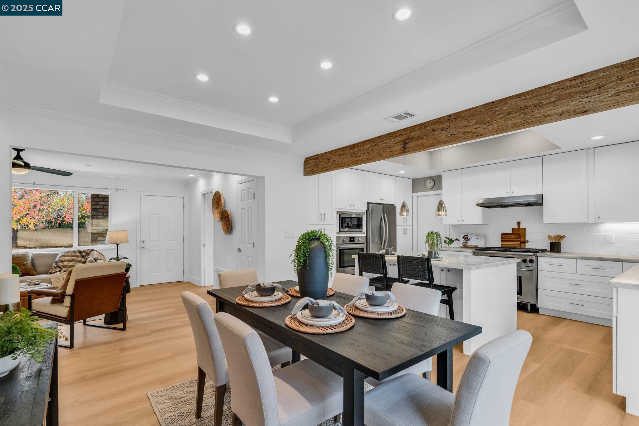 4597 Wildcat Lane Concord, CA 94521 - Photo 12 of 57 a kitchen with stainless steel appliances kitchen island granite countertop a dining table chairs and a microwave