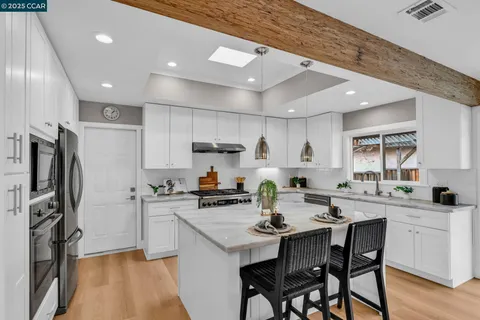 a kitchen with refrigerator and cabinets