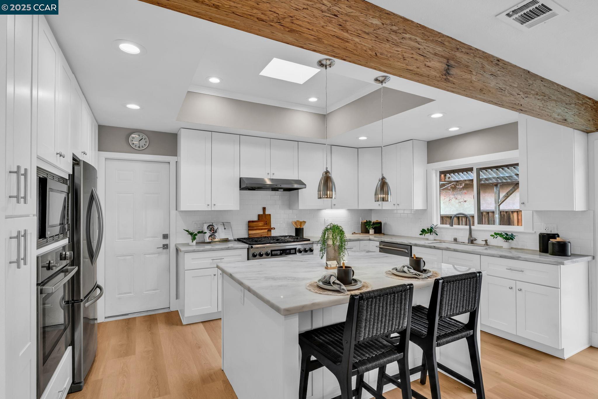 4597 Wildcat Lane Concord, CA 94521 - Photo 14 of 57 a kitchen with a sink a refrigerator and wooden floor